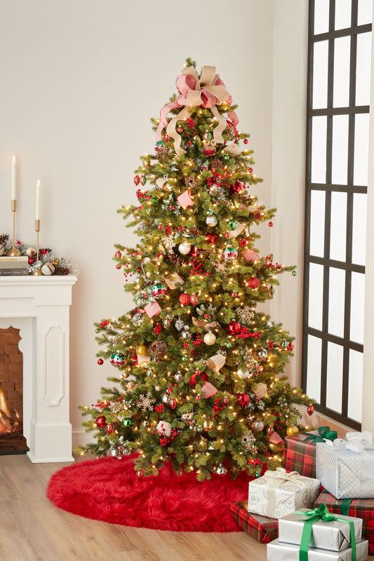 Red furry tree skirt, 5' round, around the base of a Christmas tree with warm white lights, pink ribbons, red and gold ornaments, and wrapped gifts.
