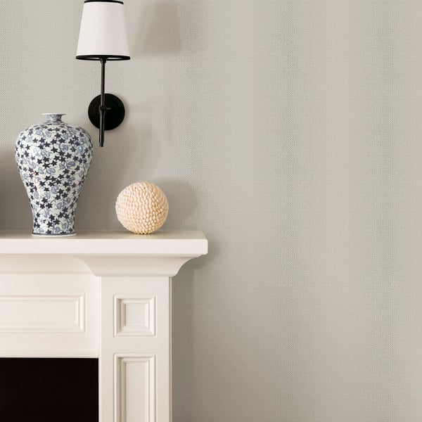 Silver-grey wallpaper with a subtle weave texture.