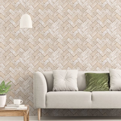 Cream sofa with white and green cushions, wooden side table with plant and cup, beige herringbone wallpaper, pendant lamp.