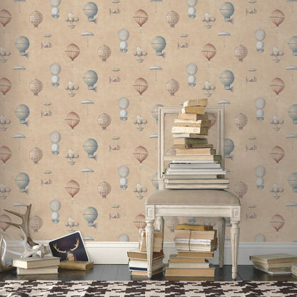 Vintage white chair stacked with books against pastel balloon-pattern wallpaper; extra books on the floor.