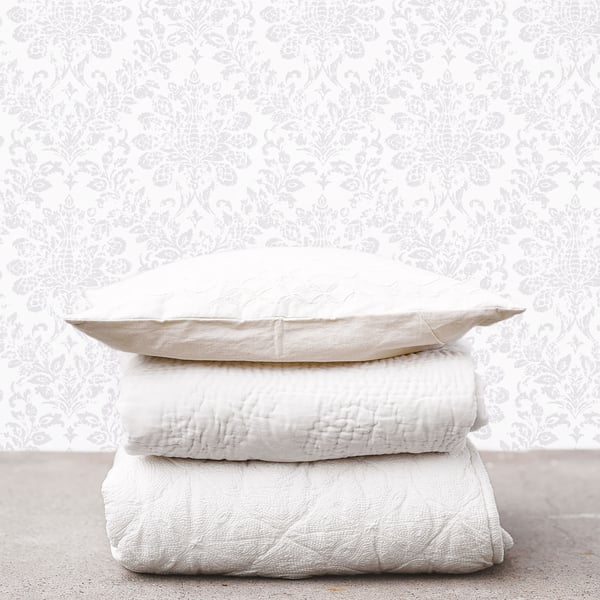 Silver grey damask wallpaper with a textured surface.