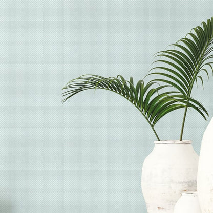 Mint-green wallpaper with small, subtle prints.