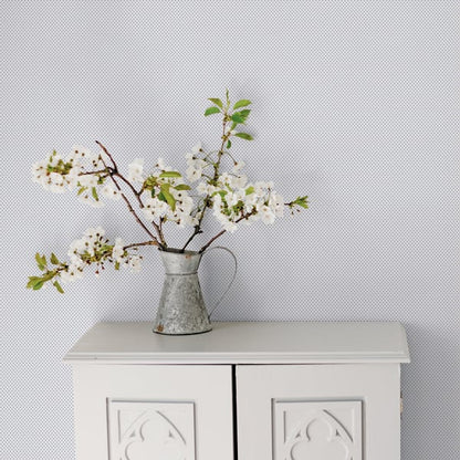 Wallpaper with a tiny blue tulip print on a white background.