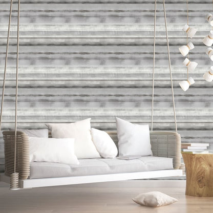 Cream woven wallcovering with a gray stripe pattern on the wall; rope hanging from the ceiling above a wooden stump table with books.