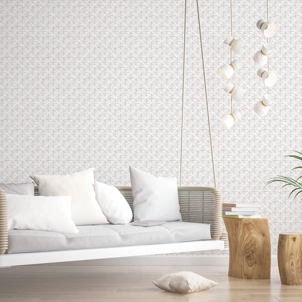 Neutral living room with walls covered in silver grey block-print wallpaper.