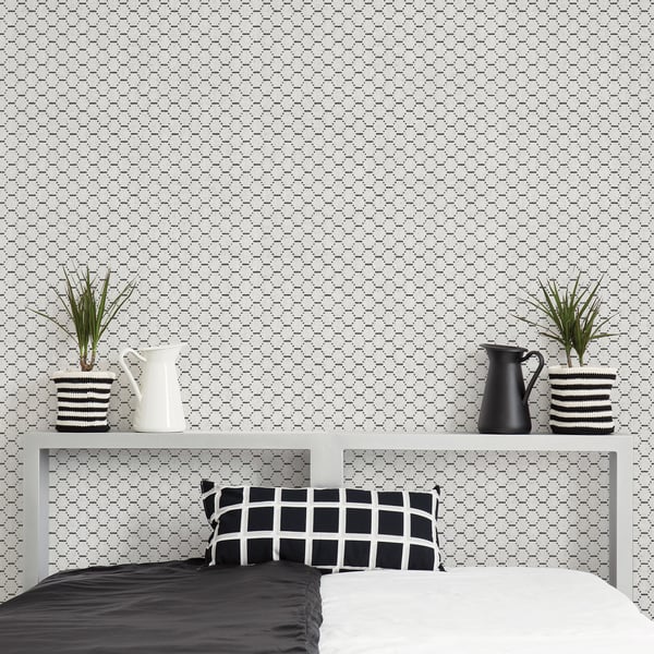 Monochrome bedroom with grey shelf, two-tone bed, black/white grid pillow, striped plant pots, white & black pitchers.