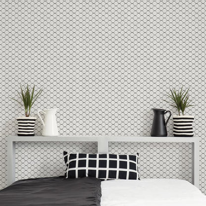 Monochrome bedroom with grey shelf, two-tone bed, black/white grid pillow, striped plant pots, white & black pitchers.