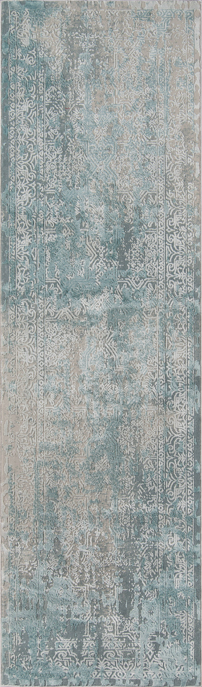 Blue-gray distressed vintage area rug with faded floral pattern; rectangular rug in muted teal, ivory and gray tones.