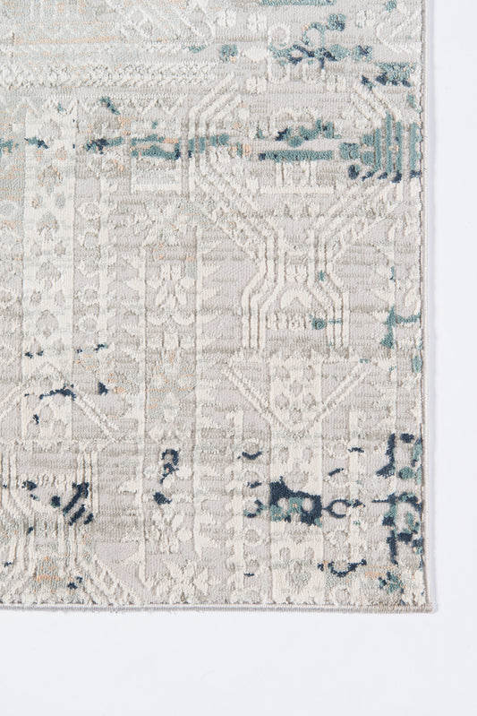 Cream distressed geometric area rug with teal/blue accents; vintage tribal weave.