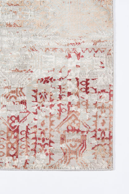 Rug with red geometric motifs on cream-beige background; vintage, distressed look, woven texture.