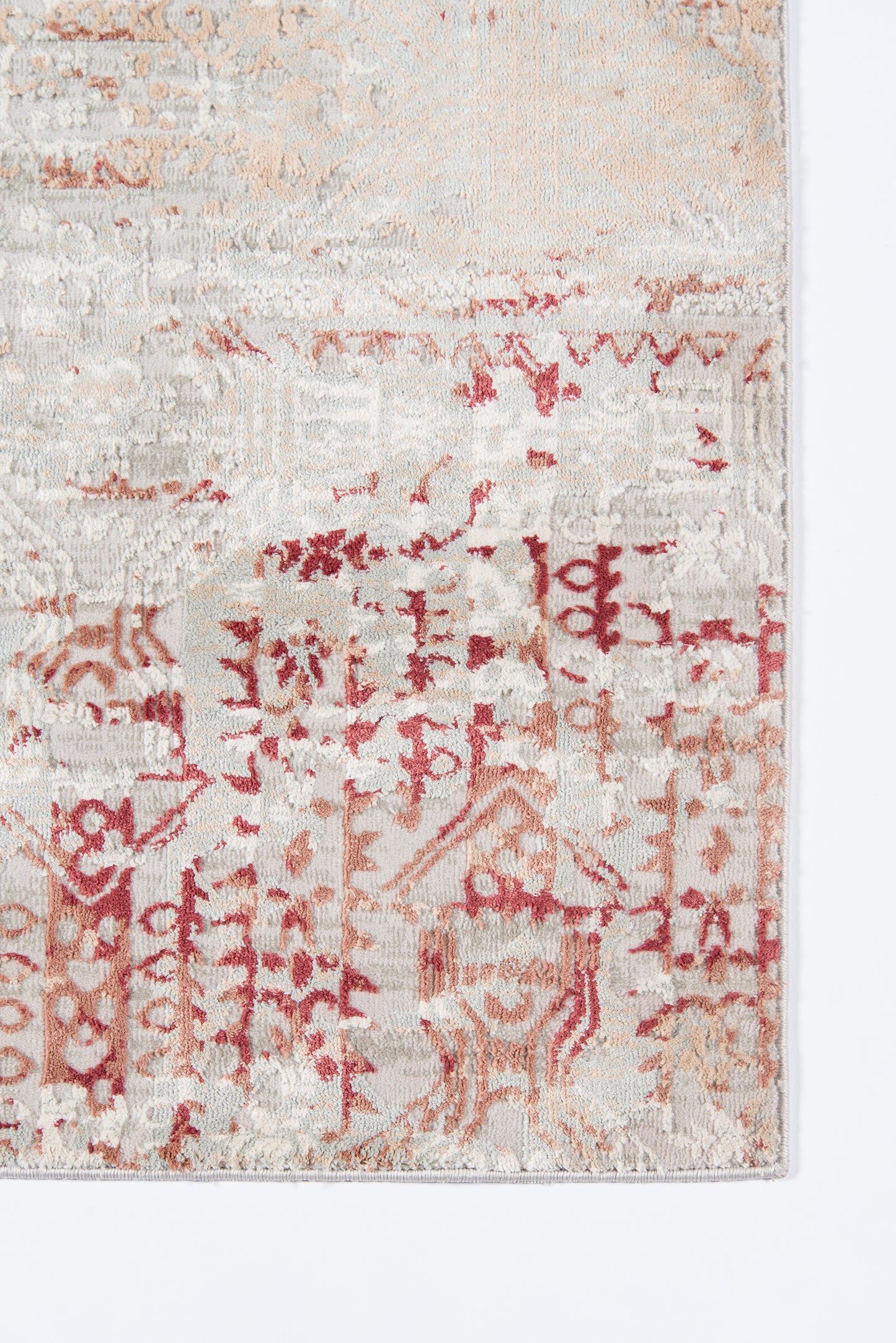 Rectangular vintage-style rug in cream and red with faded geometric/oriental motifs.