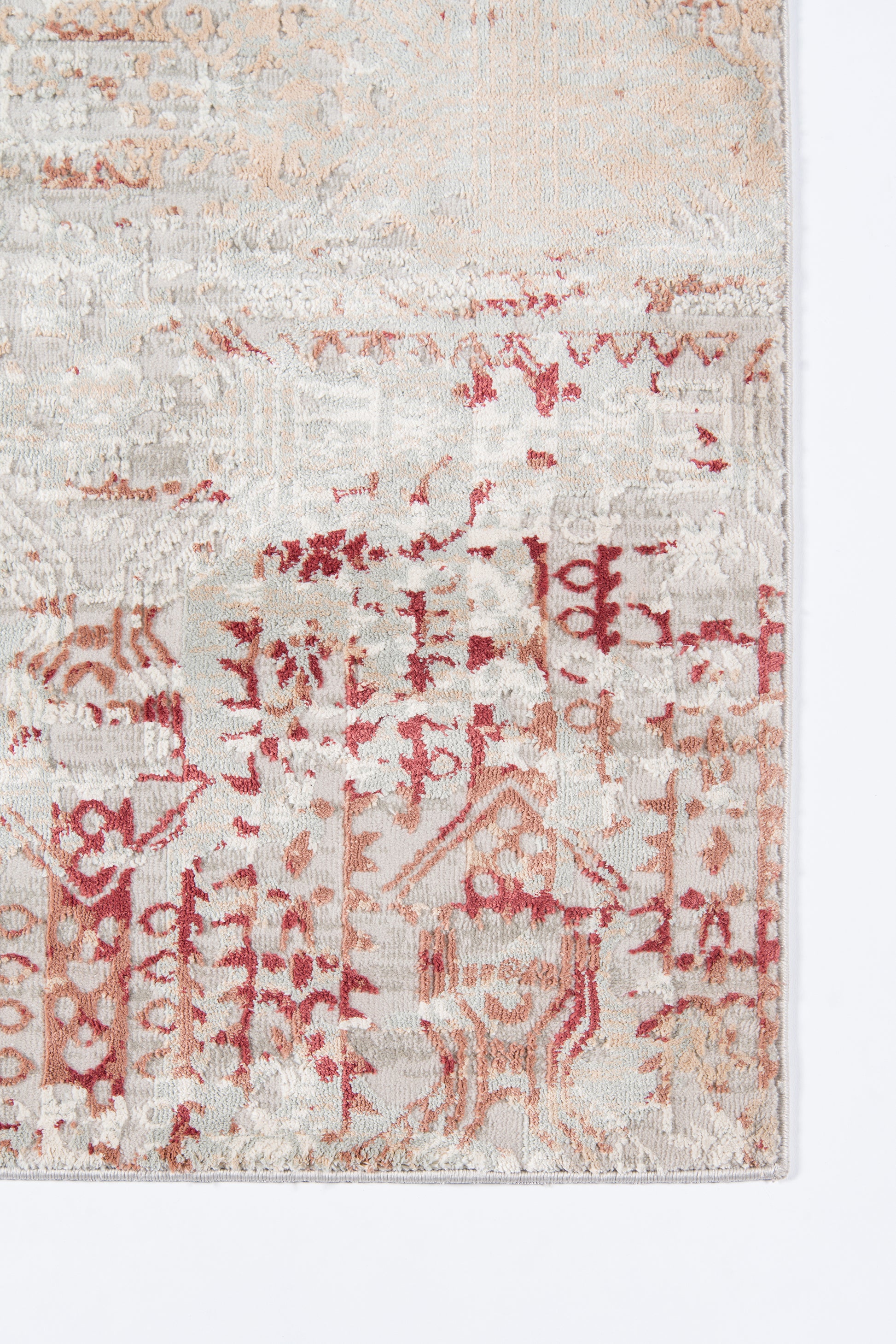 Rectangular vintage-style rug in cream and red with faded geometric/oriental motifs.