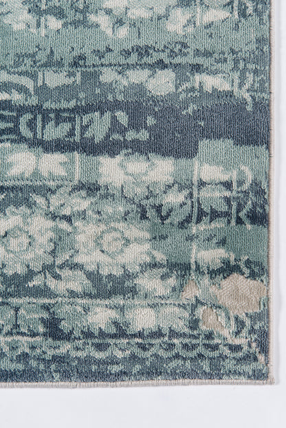 Blue Geneva-style distressed woven rug in teal and navy with beige fringe.