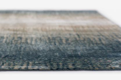 Blue gradient woven rug with beige accents; modern abstract area rug, close-up edge.