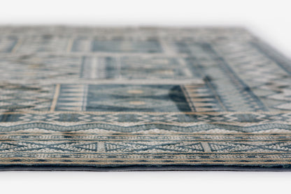 Blue and beige geometric rug, woven with traditional border pattern, close-up edge view.