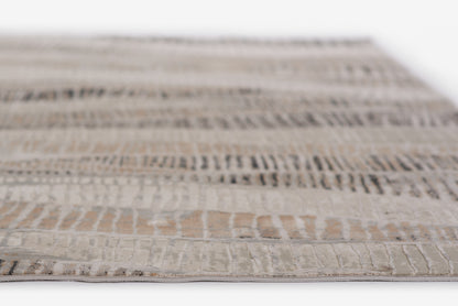 Neutral woven rug in cream, taupe & gray with a textured geometric pattern; rectangular, modern tribal style.