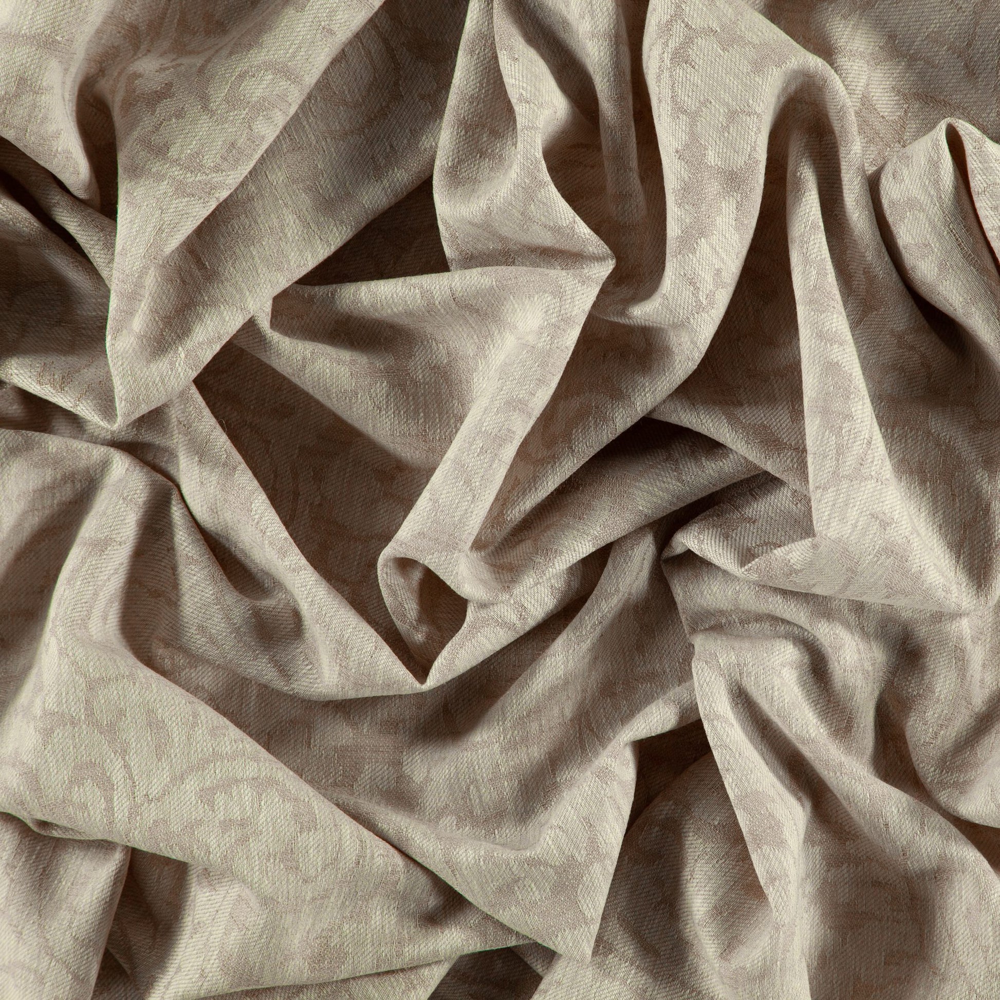 Beige jacquard damask fabric with subtle floral pattern and soft, flowing folds.