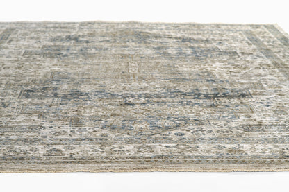 Rectangular blue-gray and beige distressed area rug with a vintage oriental pattern; soft, flat-weave look.