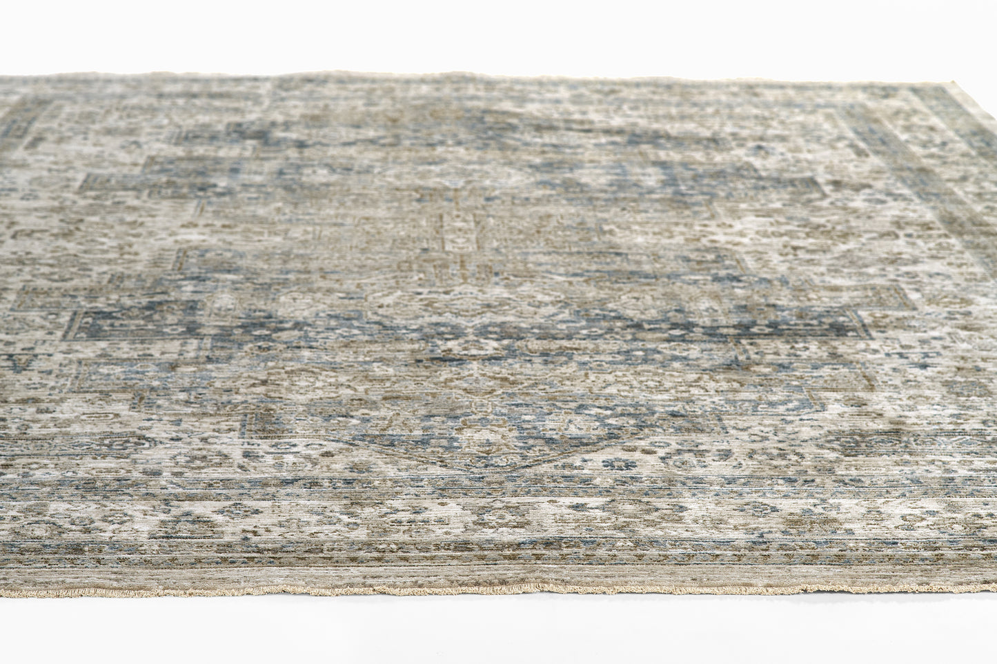 Rectangular distressed blue-gray oriental-style rug with a muted antique pattern.
