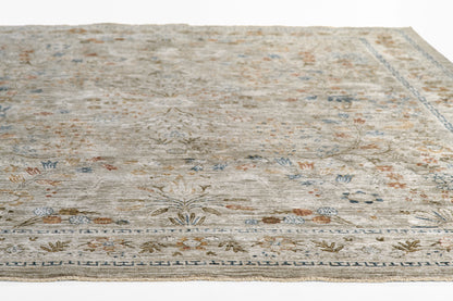 Grey-beige distressed oriental area rug with floral motifs & bordered trim, blue & rust accents.