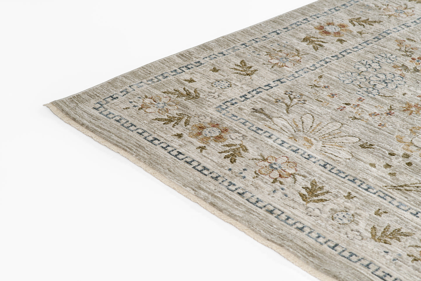 Beige oriental-style rug with muted floral pattern and blue Greek-key border.