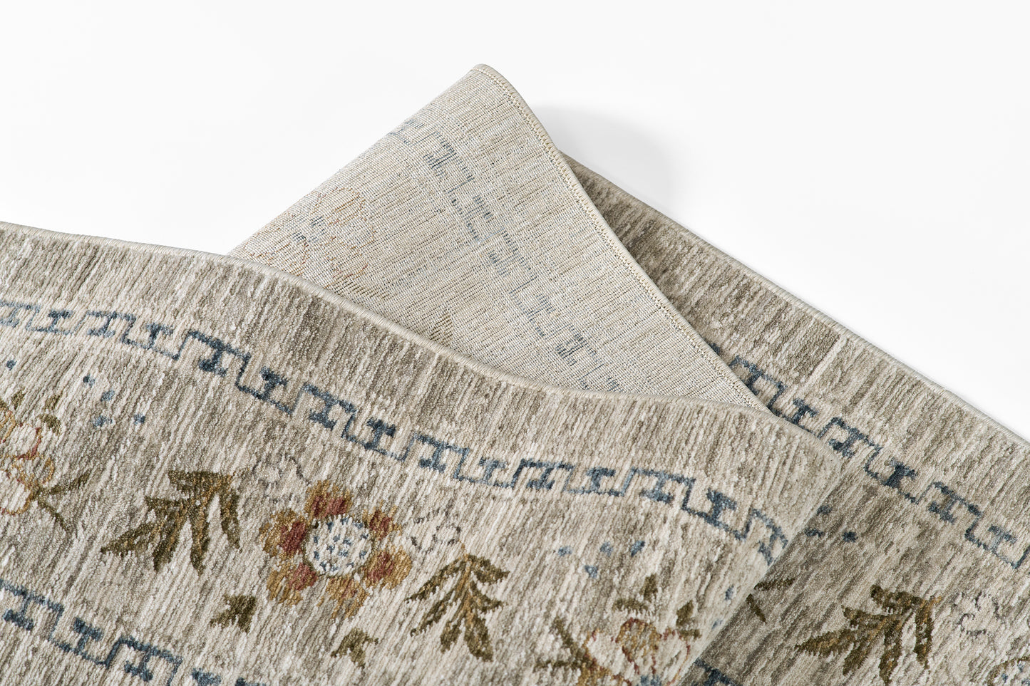 Georgian-style beige woven rug with subtle floral motifs and blue Greek-key border.