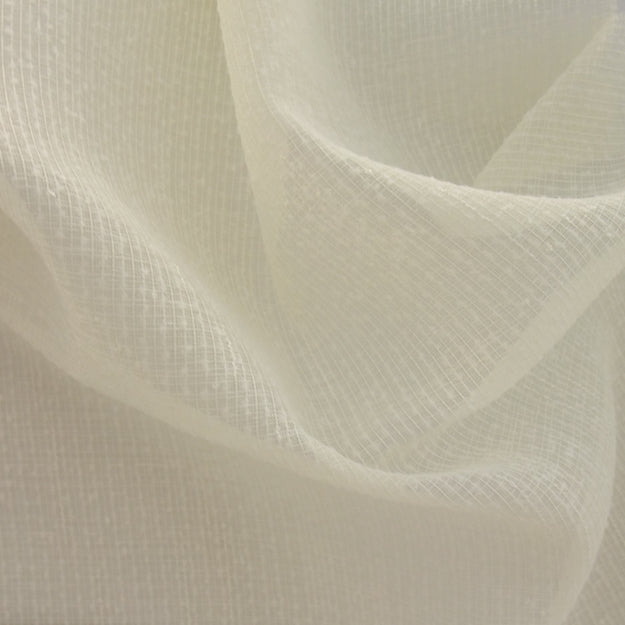 Cream sheer fabric with a fine grid texture and soft draped folds.