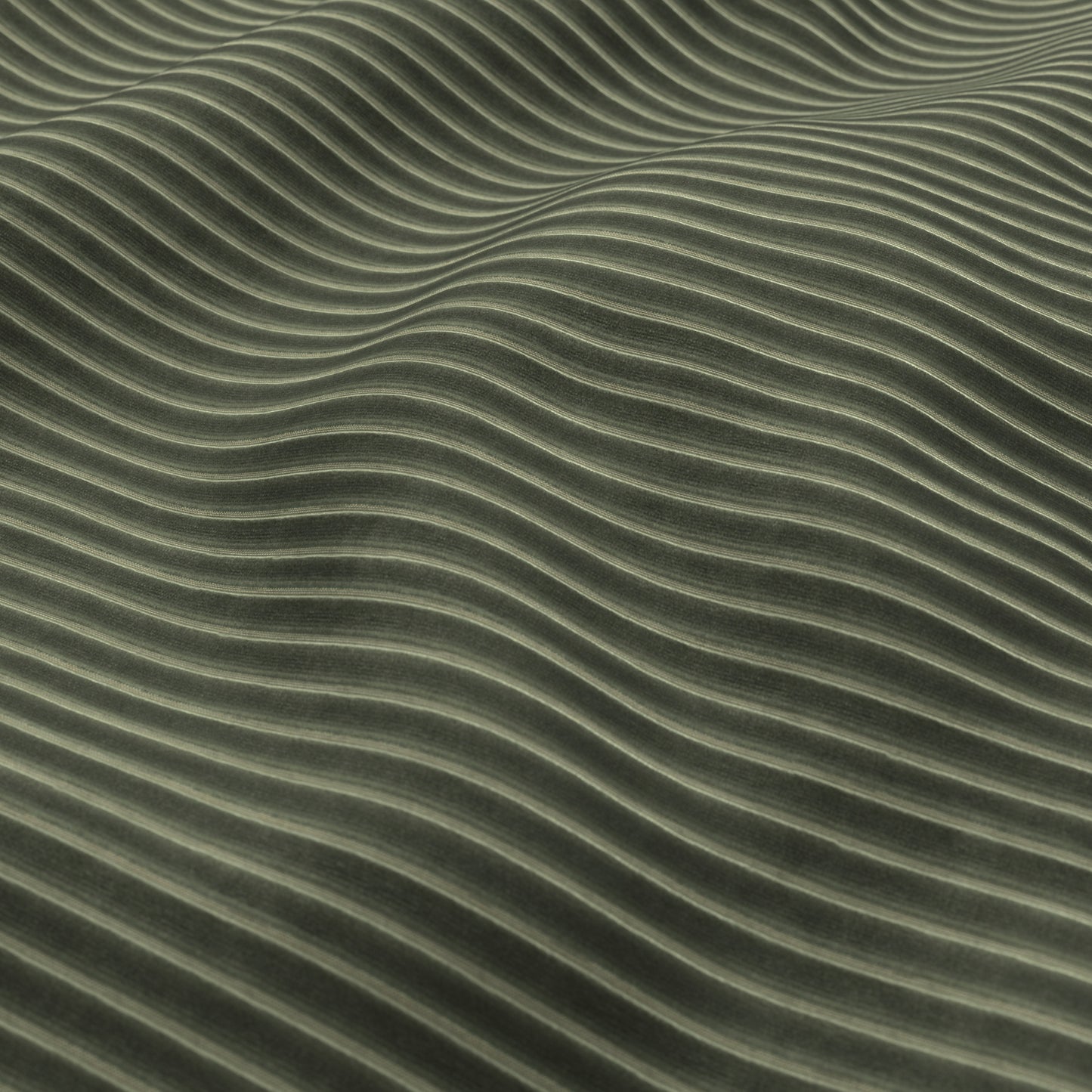 Close-up of olive-green velvet corduroy fabric texture with soft parallel ridges.
