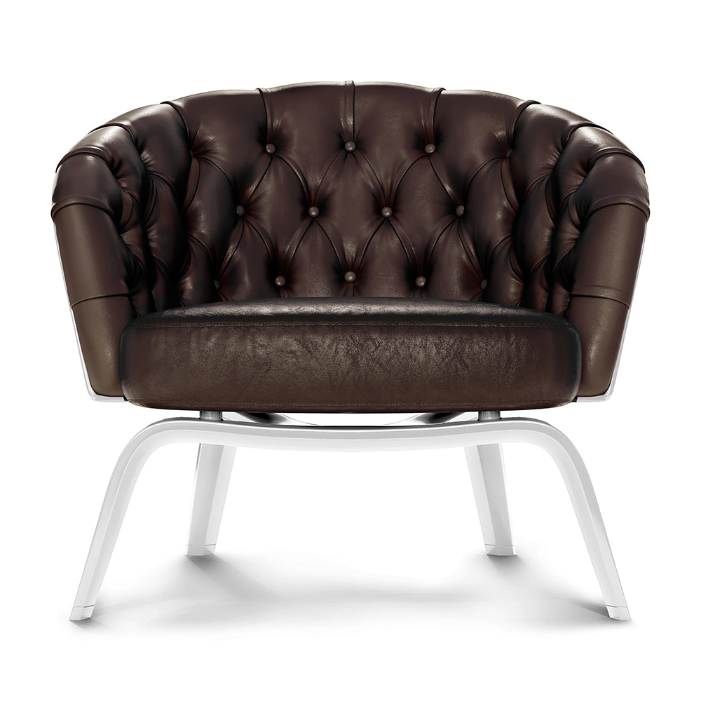 Brown tufted leather lounge chair with button-tufted back and seat on white metal frame.