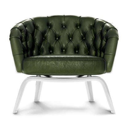 Dark green tufted leather lounge chair with buttoned back and white curved metal legs.