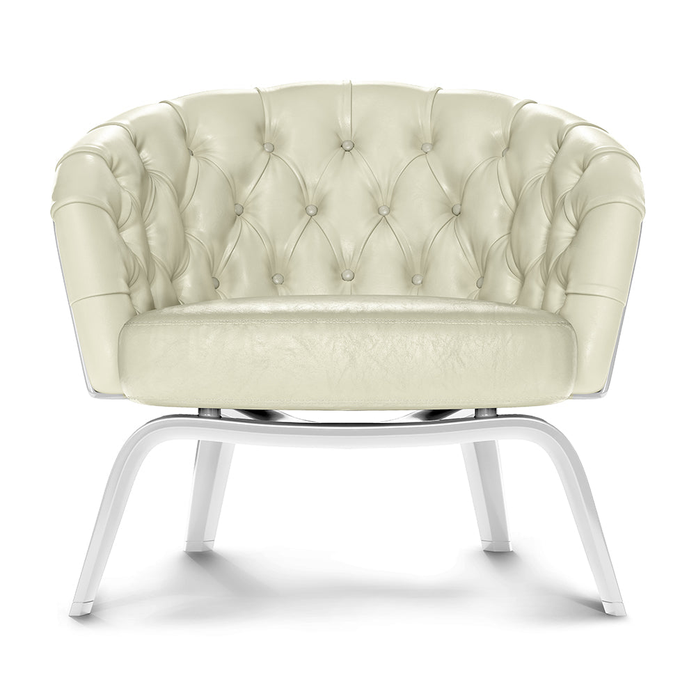 Cream tufted leather lounge chair with a buttoned back, rounded arms and plush cushion on a white curved metal frame.