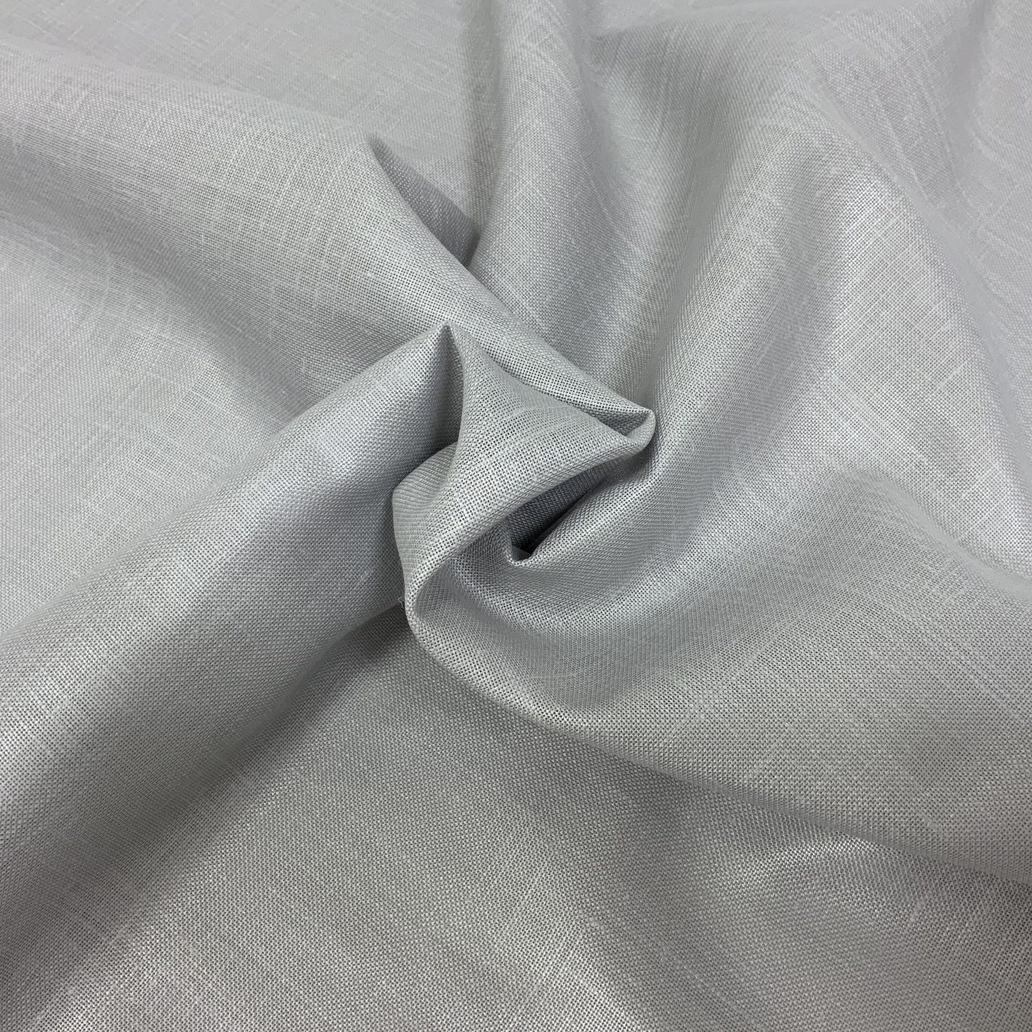 Light gray linen-like fabric with subtle weave texture and soft drape, twisted into a knot.