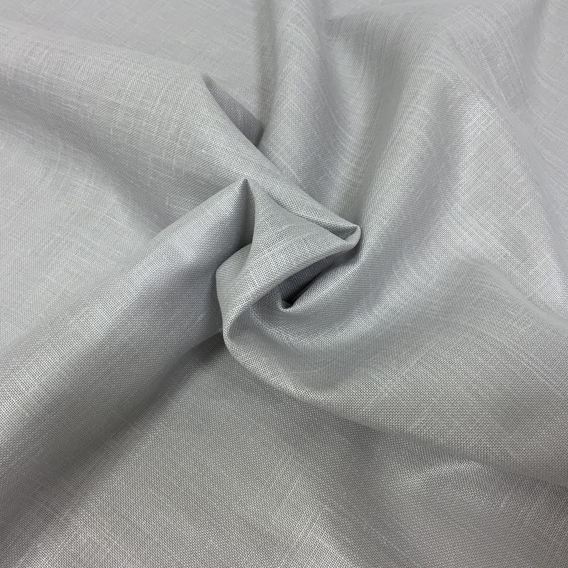 Light gray linen-like fabric with subtle weave texture and soft drape, twisted into a knot.