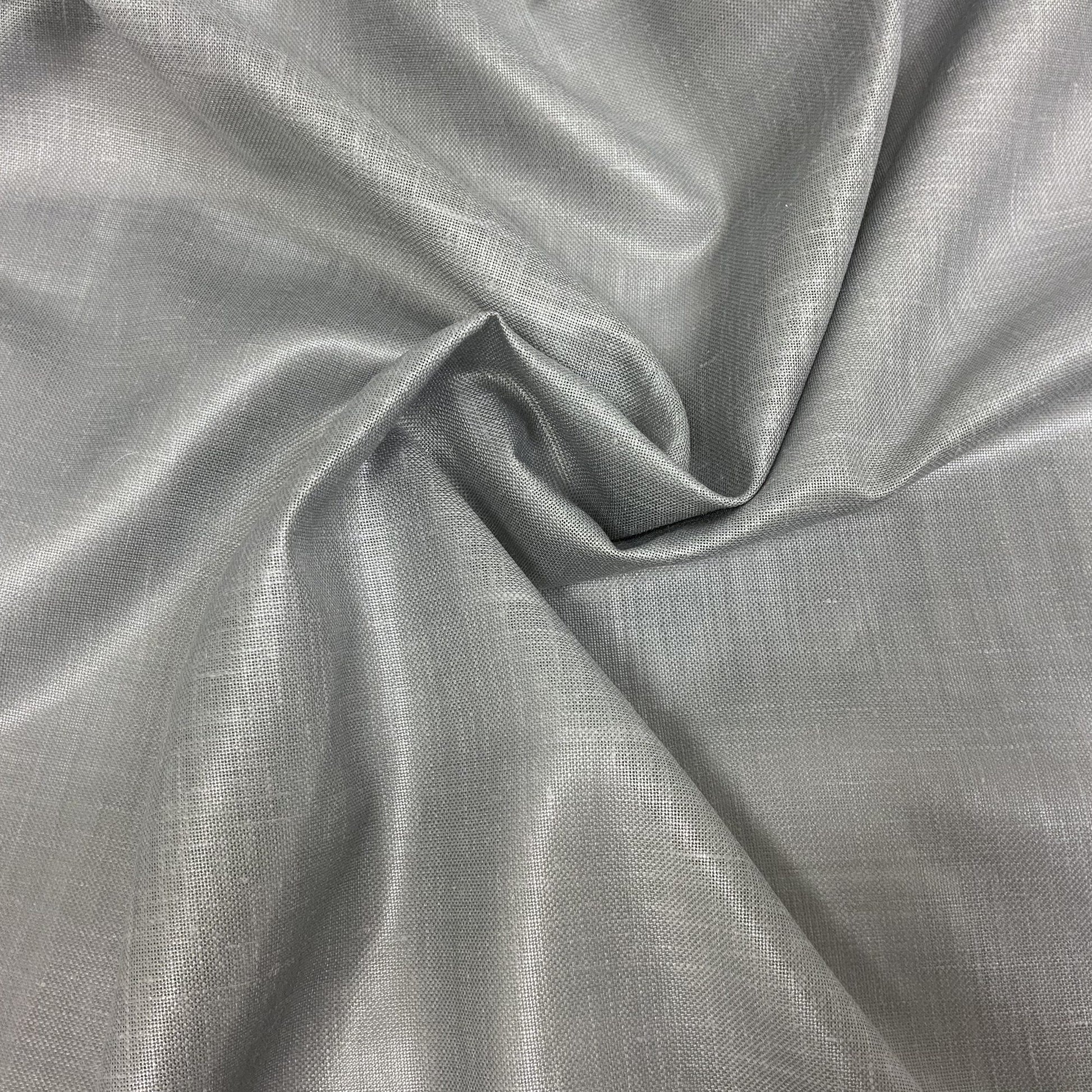 Light gray sheer fabric draped in soft folds to show texture.