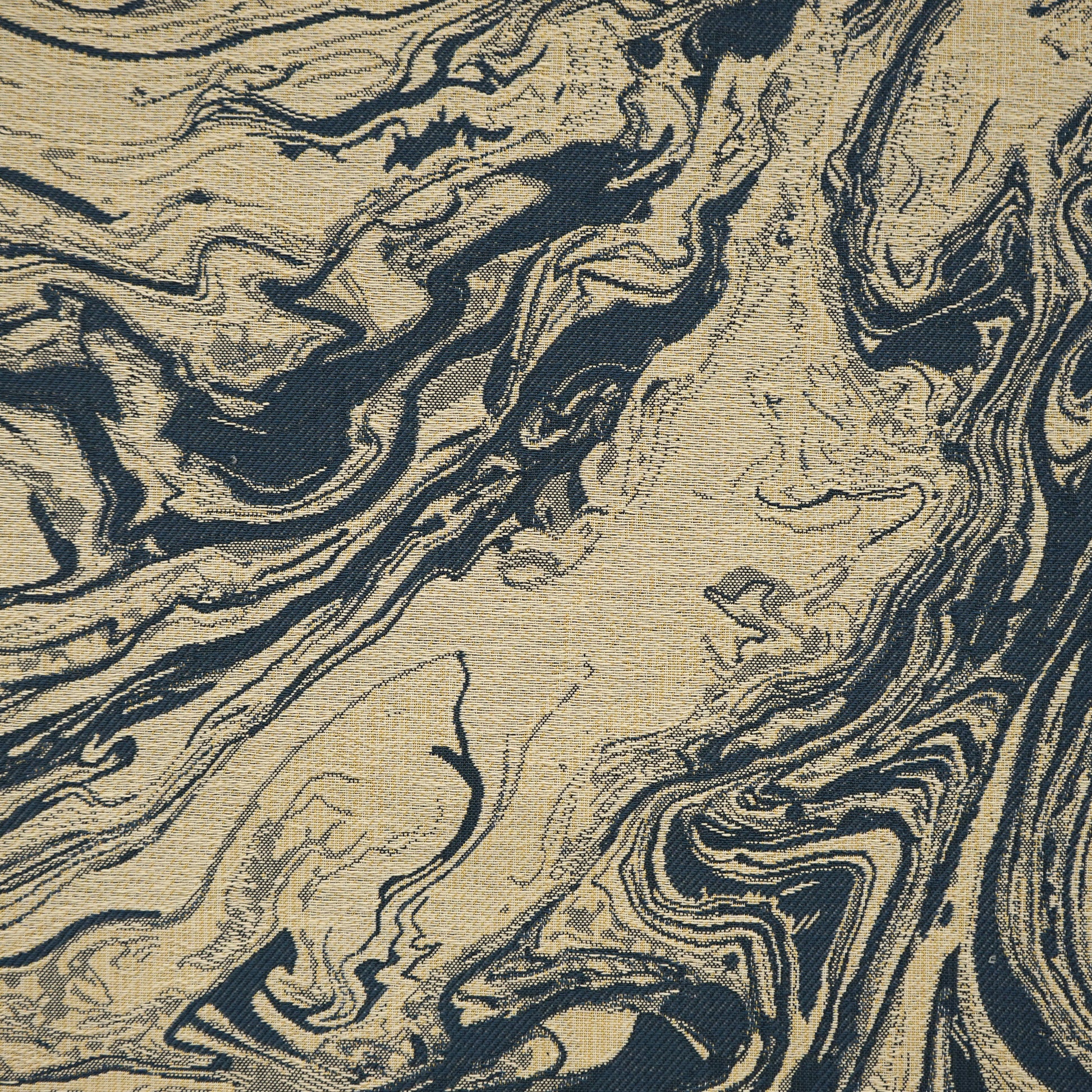 Beige, creme and blue marbled fabric texture with abstract swirls; suitable for upholstery.