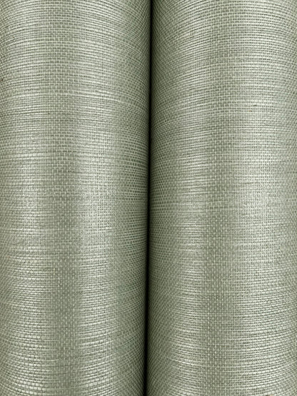 Two olive-green grasscloth wallpaper rolls with a linen-like weave.