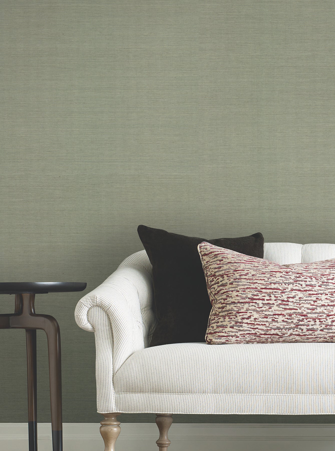 Cream textured wallpaper with a desert sage grasscloth pattern on the wall.