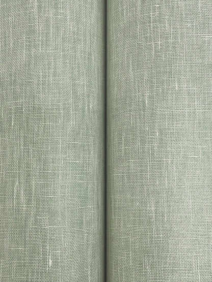 Close-up of sage green linen-look wallpaper with a textured crosshatched weave and a central seam.
