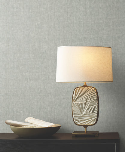 Room featuring sheer linen-style wallpaper in ash tones with a subtle woven texture.