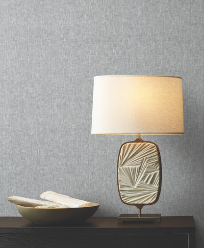 Room scene with blue wallcovering featuring sheer linen texture and natural weave pattern on the walls.