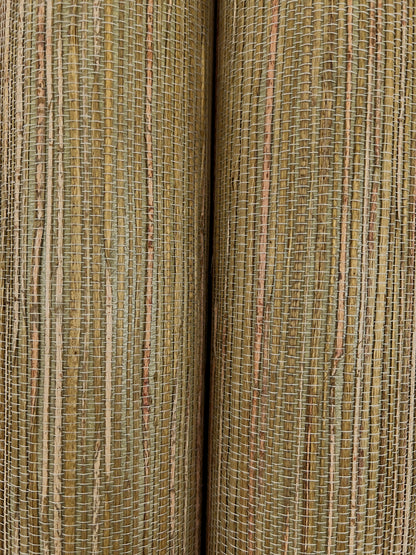 Close-up of two rolled natural woven wallpaper samples with vertical tan and brown stripes.