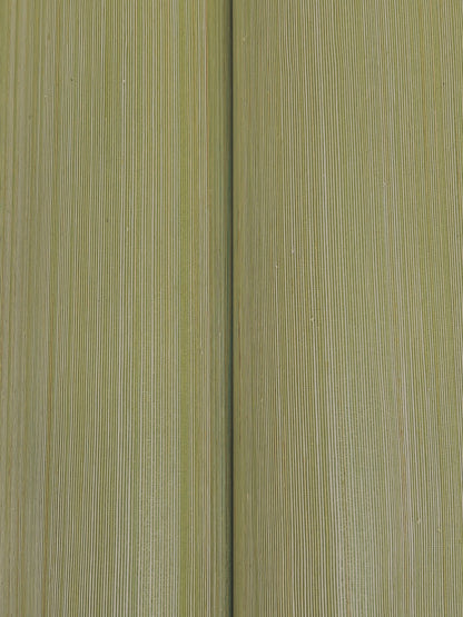 Close-up of olive-green abaca moss grasscloth wallpaper texture, showing fine fibers and a central seam.