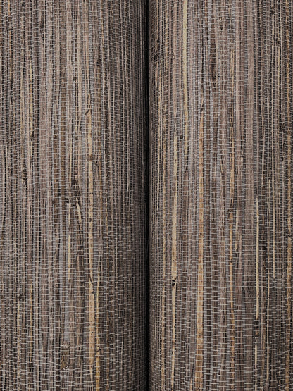 Close-up of striped woven rug fabric in beige and brown tones with a textured jute-like weave.