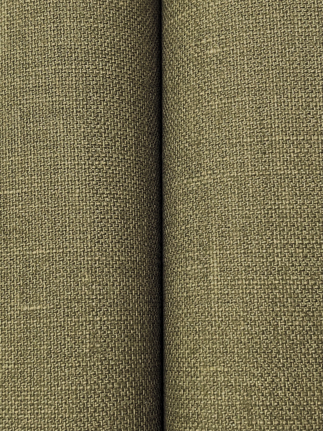 Close-up of olive-green woven fabric with a tight canvas-like texture; upholstery style.