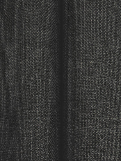 Close-up of charcoal woven fabric with subtle grid texture and soft folds; ideal for upholstery or curtains.