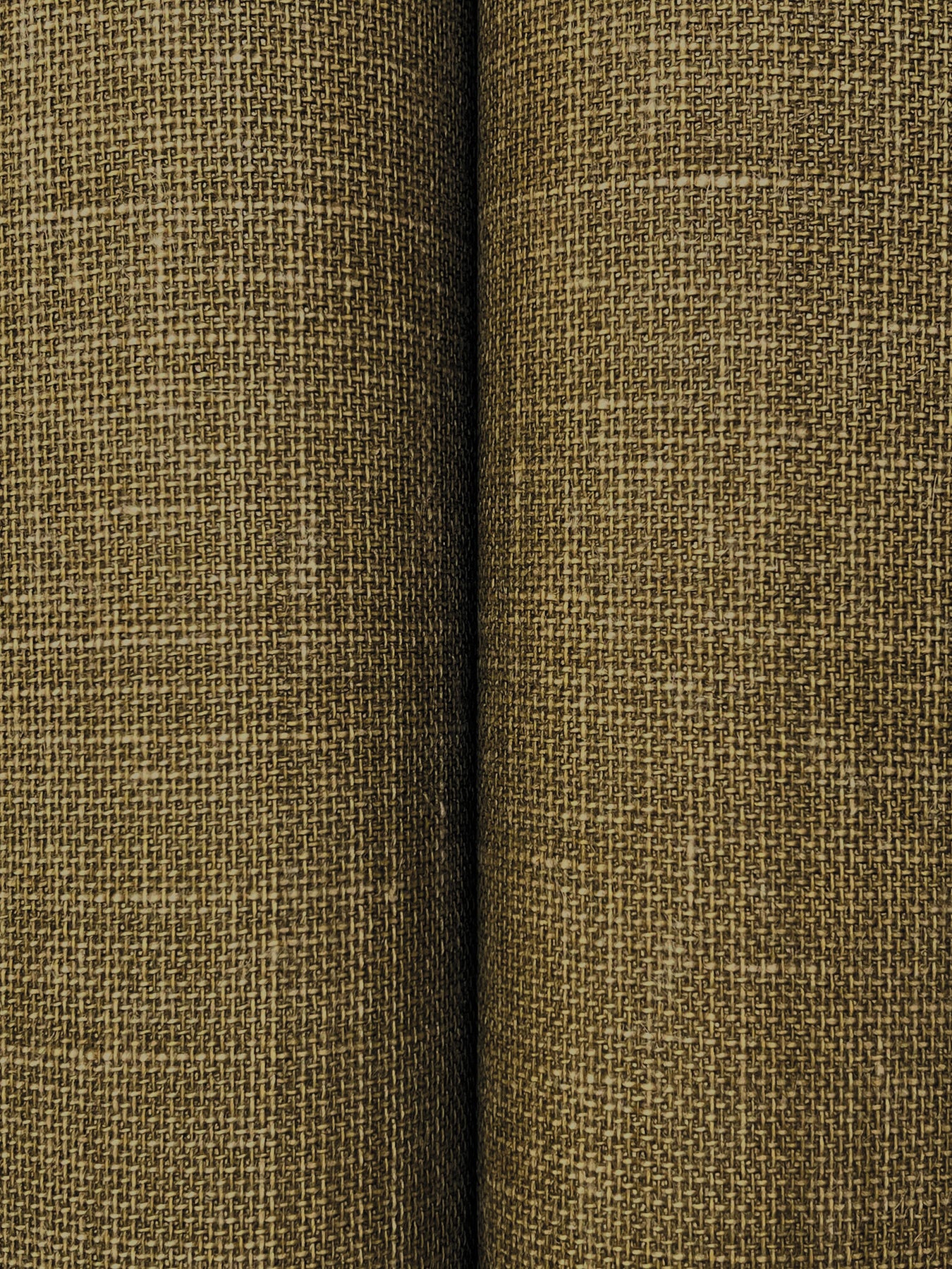 Olive-brown woven fabric close-up with coarse linen texture and a vertical seam between panels.