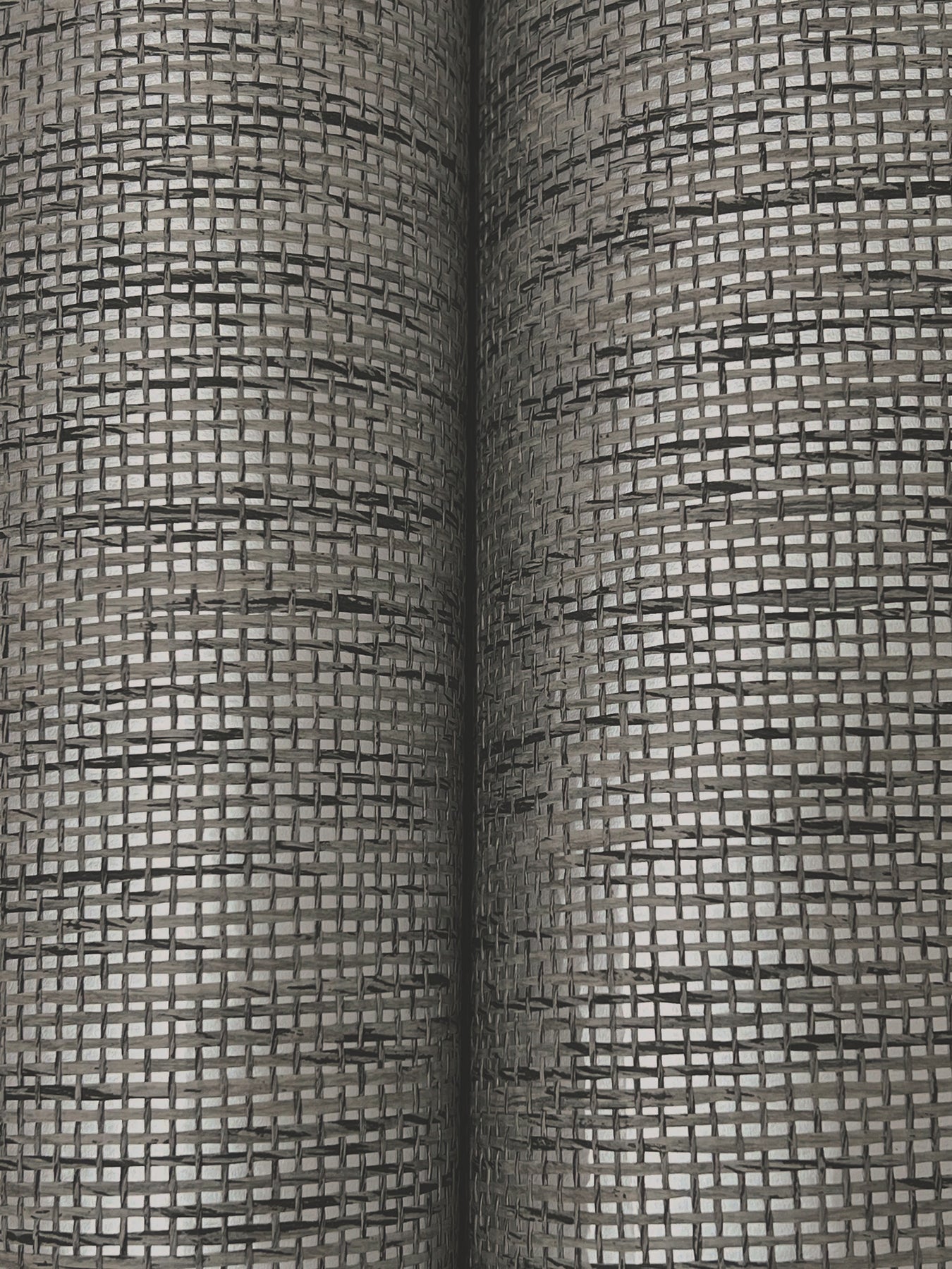 Close-up of two gray grid-patterned Paperweave wallpaper swatches.