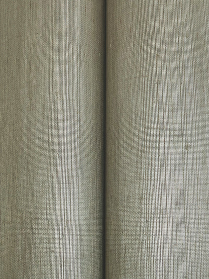 Close-up of two beige-gray wallpaper rolls with a tight vertical weave and textured surface.