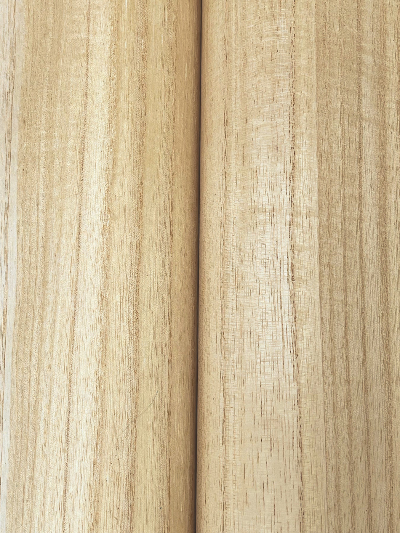 Two light blonde wood planks with visible grain and a central seam; smooth natural finish.