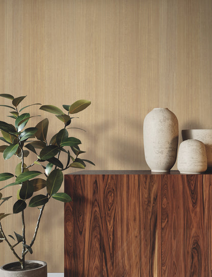 Honey wood-veneer wallpaper as a warm backdrop, with beige ceramic vases and a leafy potted plant.